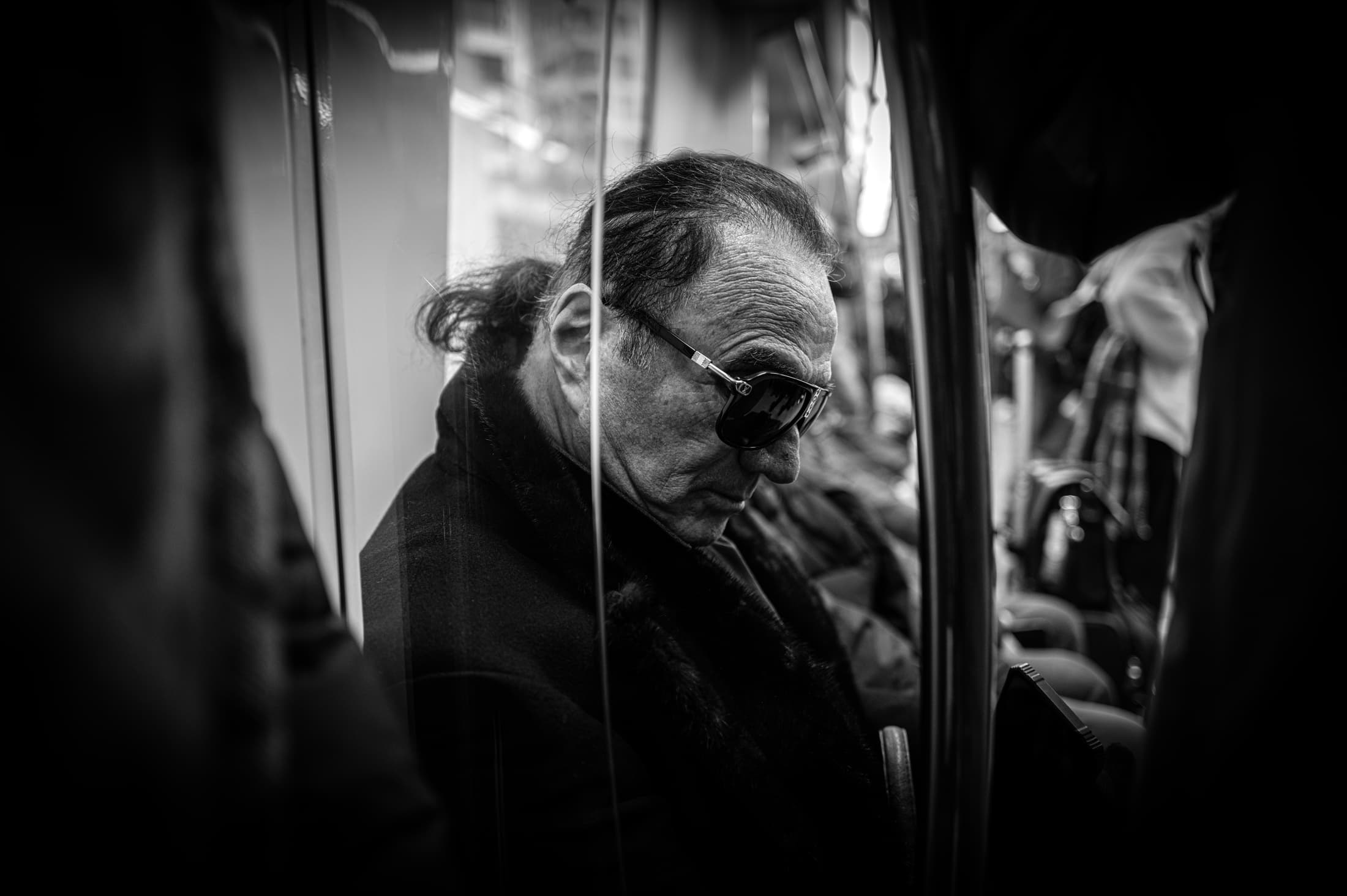 A passenger seen through glass in İstanbul, photographed by Ali Alışır